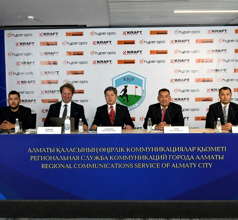 Five men in suits sit on a conference table in front of a banner with Hyper Optic, Kraft, and KFGF logos.